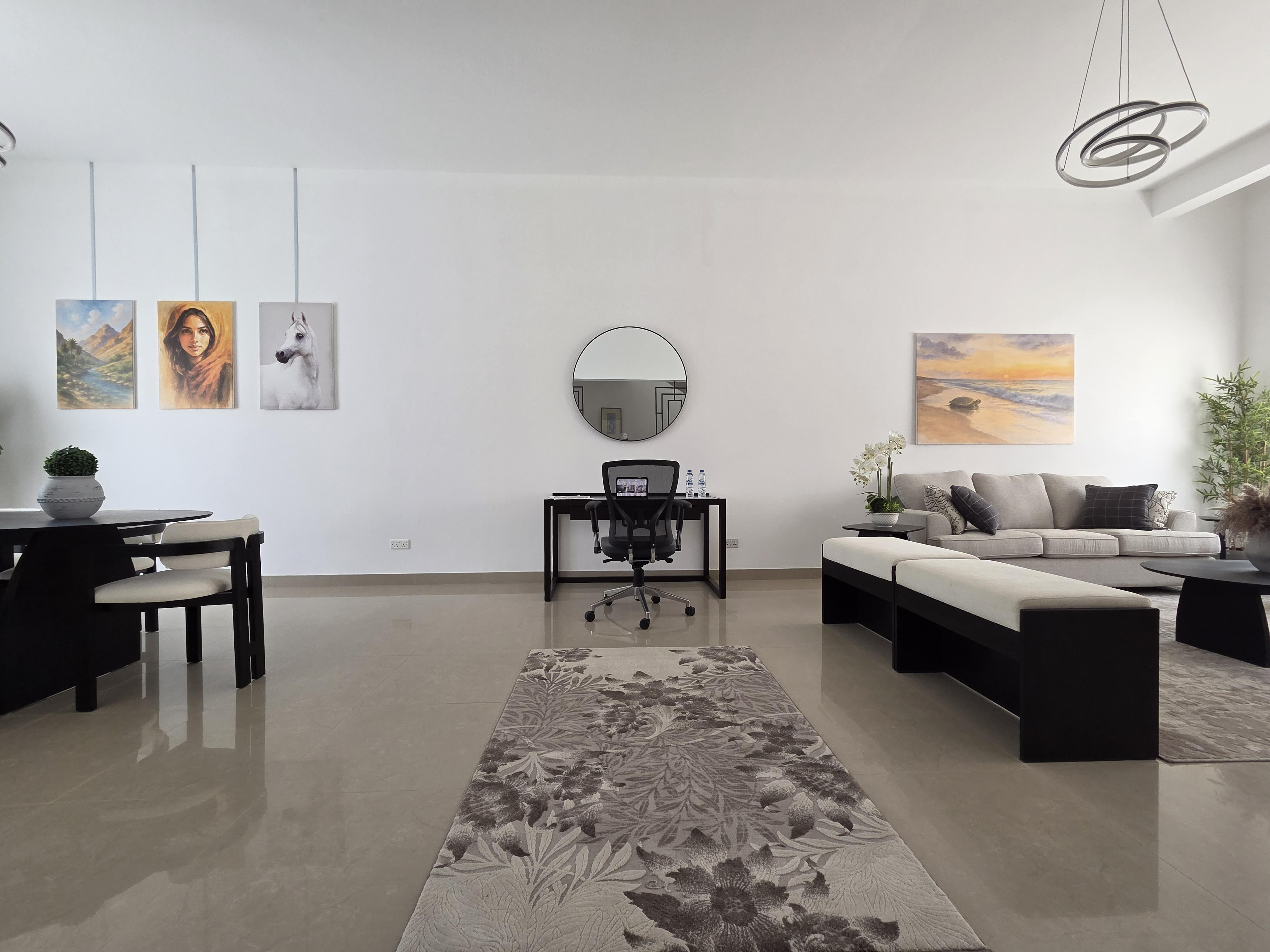 Front desk area with a dark wood counter, backlit shelving and eclectic decor.